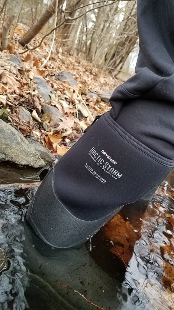 Person standing in a cold creek wearing Dryshod Arctic Storm boots